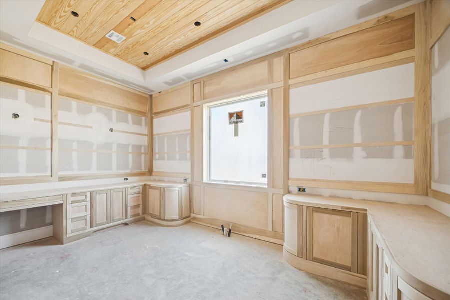 The primary bathroom showcases an impressive layout with room for double vanities and a vaulted ceiling that will anchor the room’s custom millwork. The framing highlights the scale and symmetry of the space. A spa-level retreat in progress.