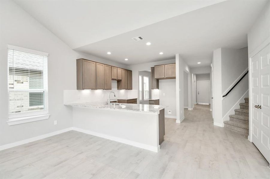 Discover another perspective of this beautiful kitchen! Example photo of completed home with similar plan. Actual may vary.