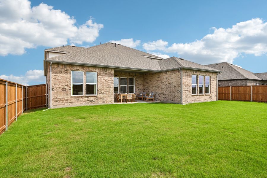 A house with a fence and grass.