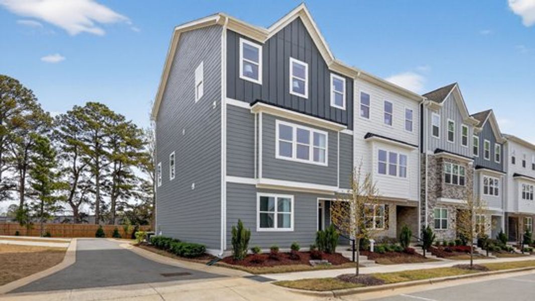 Front exterior of a new home in The Townes at Madden West, Fuquay Varina, NC, highlighting curb appeal (Image 2). Front exterior of a new home in The Townes at Madden West, Fuquay Varina, NC, highlighting curb appeal (Image 2).