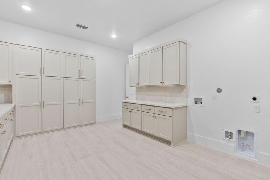 Oversized utility room for maximum functionality. Representative image.