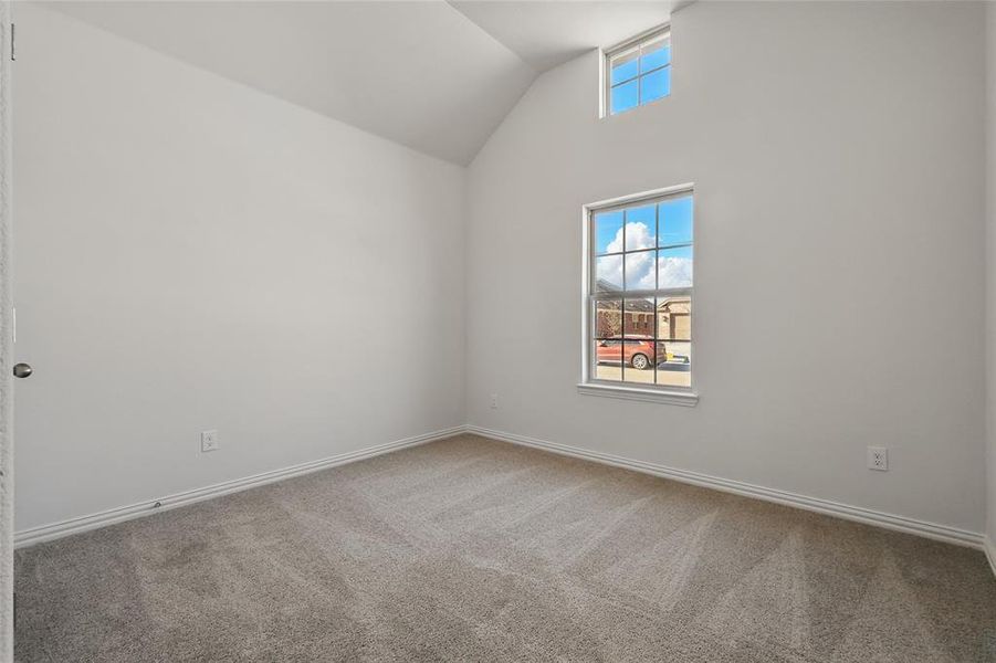 Bonus room featuring carpet floors and vaulted ceiling