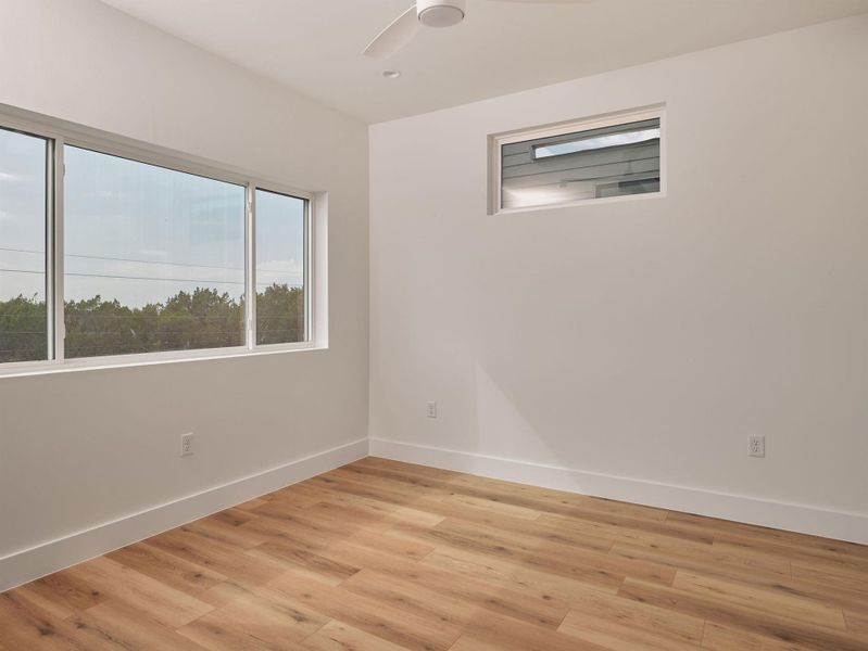 Spare room featuring light wood-style floors and baseboards