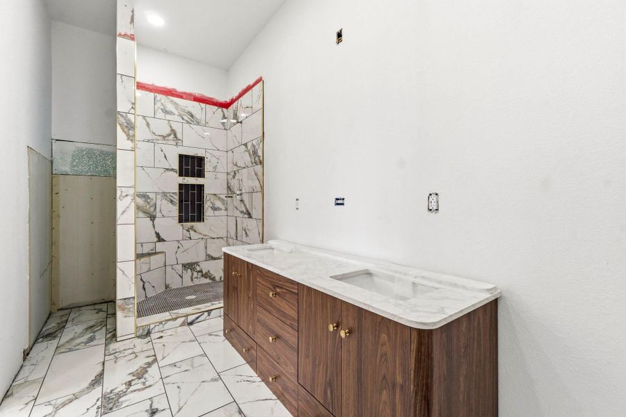 Beautiful walk-in shower with nook to the left perfect for linen storage.