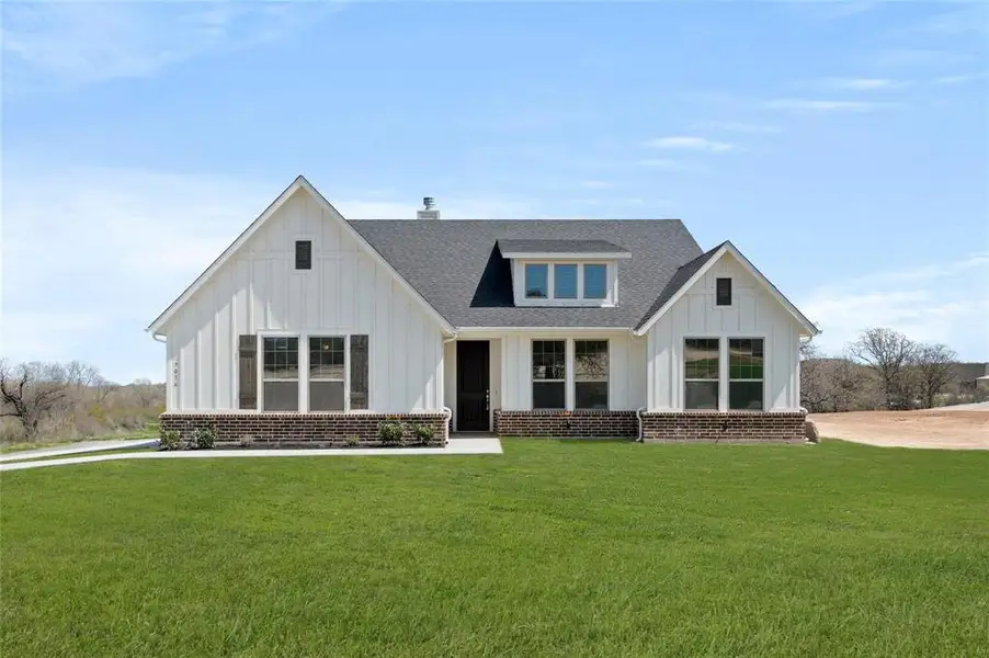 Front exterior of a new home in The Ranches at Valley View, Springtown, TX, highlighting curb appeal (Image 1). Front exterior of a new home in The Ranches at Valley View, Springtown, TX, highlighting curb appeal (Image 1).