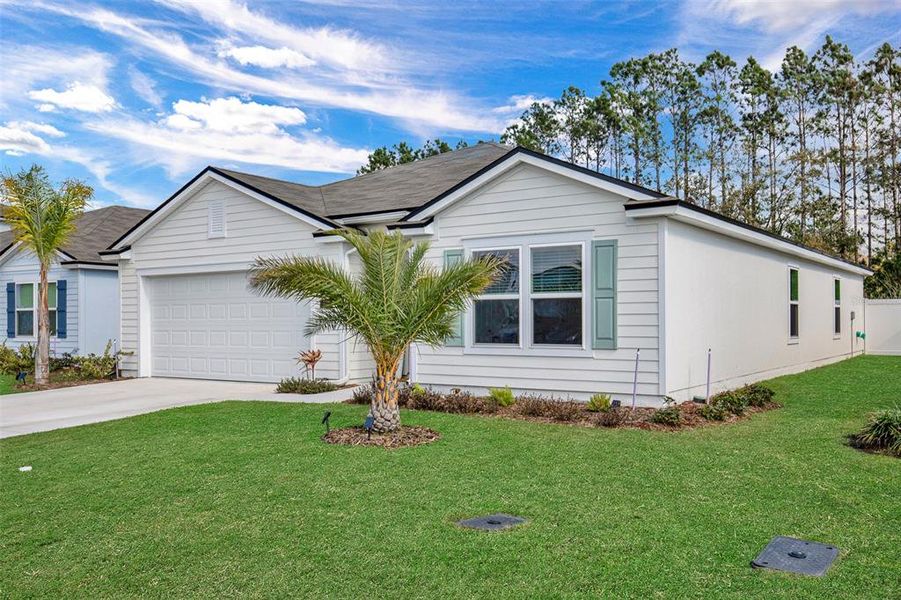 Front exterior of a new home in Sawmill Branch, Palm Coast, FL, highlighting curb appeal (Image 23).
