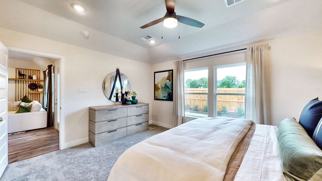 A bedroom with a large window. A bedroom with a large window.