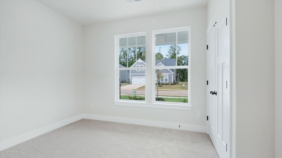 Vibrant and restful bedroom with oversized windows, refined detail, and a warm, welcoming atmosphere