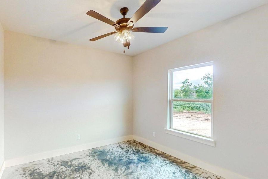 Empty room featuring ceiling fan