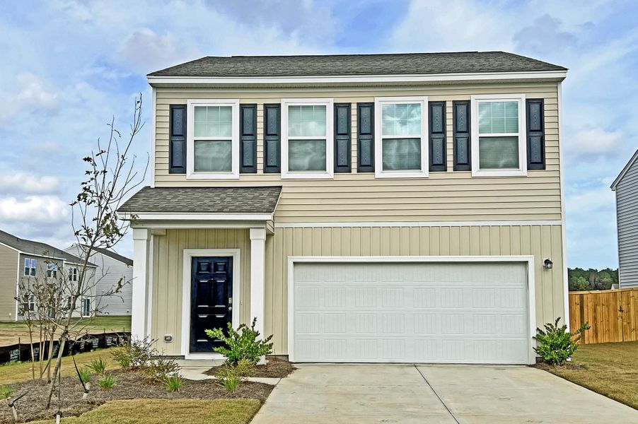 Front exterior of a new home in Pender Woods at Cane Bay, Summerville, SC, highlighting curb appeal (Image 1).