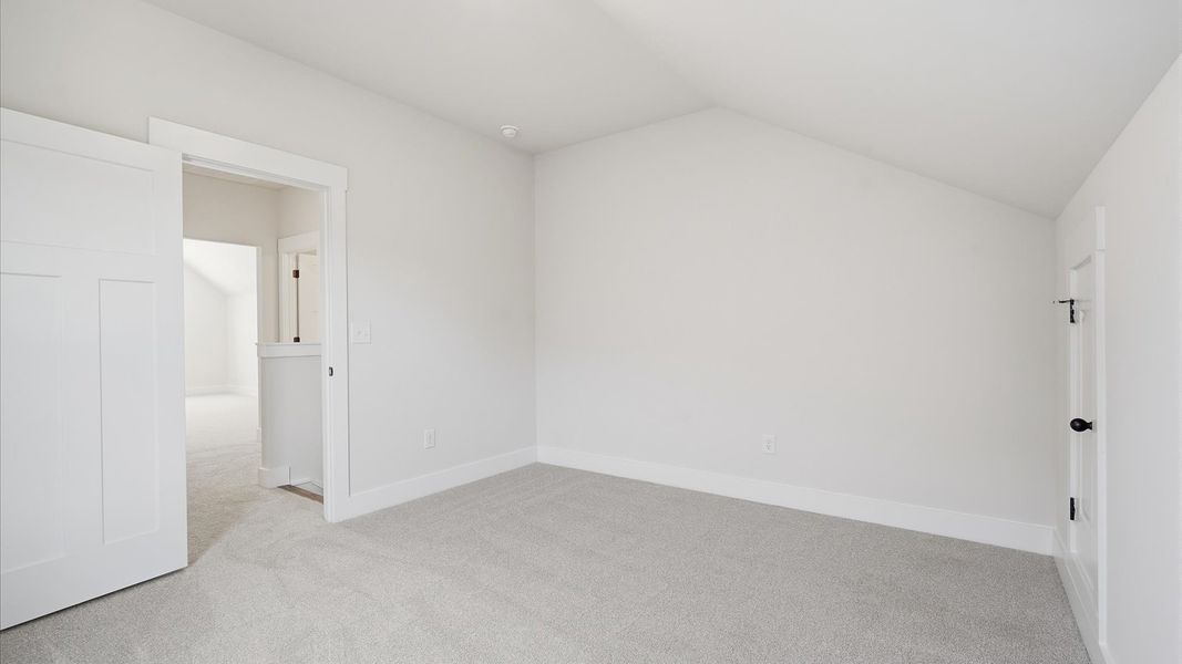 Highly functional bedroom with walk-in closet and tasteful carpet for a restful retreat Highly functional bedroom with walk-in closet and tasteful carpet for a restful retreat