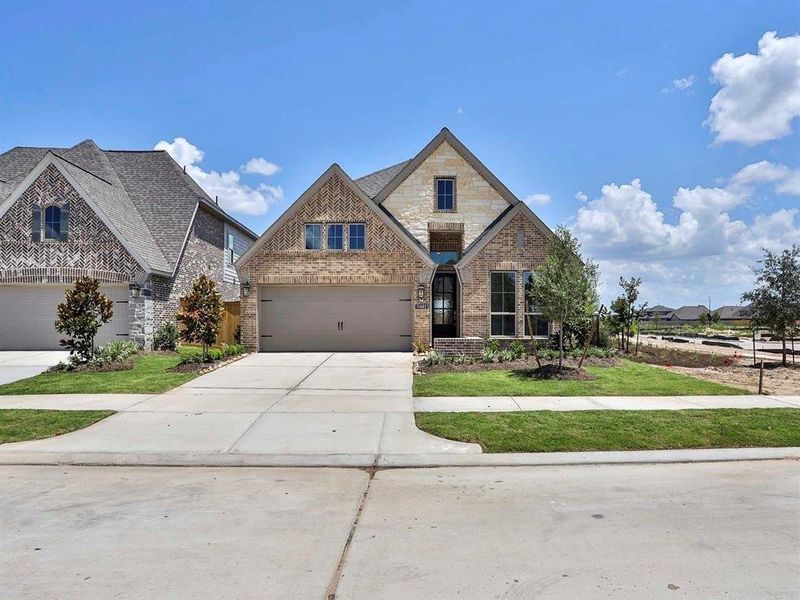 Front exterior of a new home in Bridgeland 45', Cypress, TX, highlighting curb appeal (Image 14).