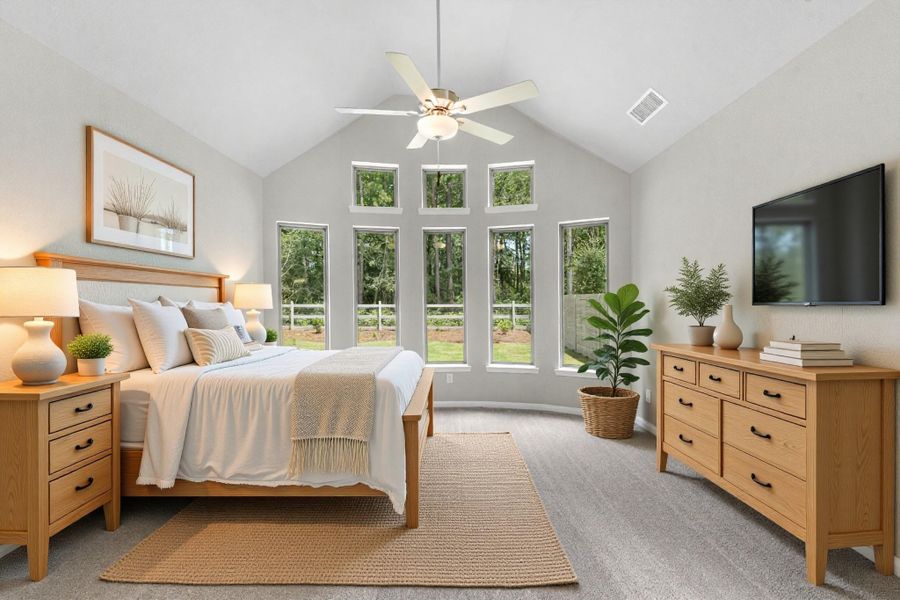 Tranquility awaits in the primary bedroom with stunning bay windows and views of the natural landscape behind!