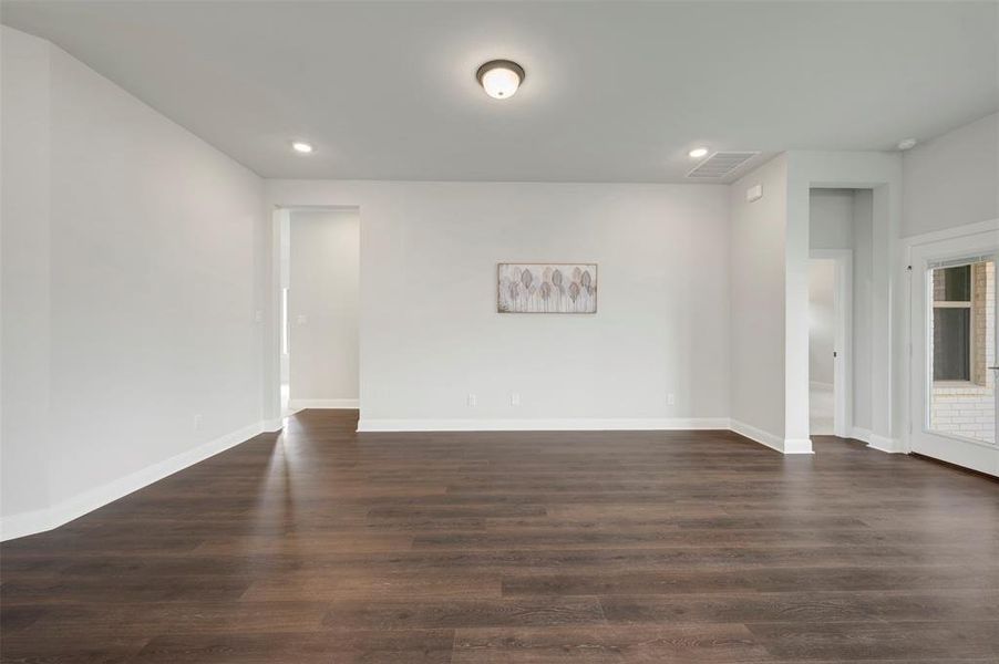 Spare room with dark wood-style floors and recessed lighting