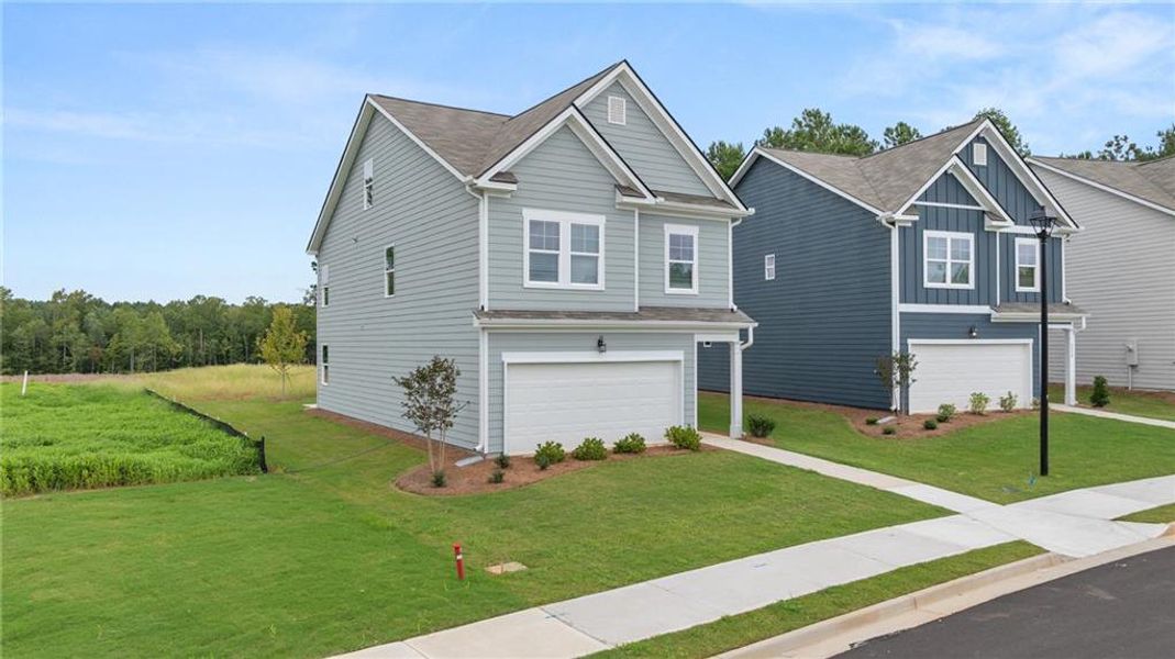 Front exterior of a new home in The Retreat at Walden Park, Jonesboro, GA, highlighting curb appeal (Image 1).