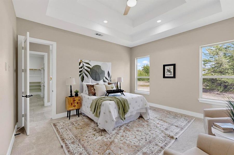 Bedroom featuring light colored carpet, a raised ceiling, ceiling fan, and recessed lighting