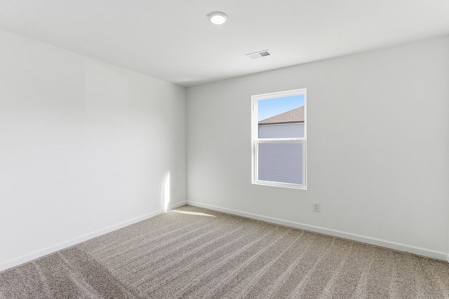 A room with a window and a carpet.