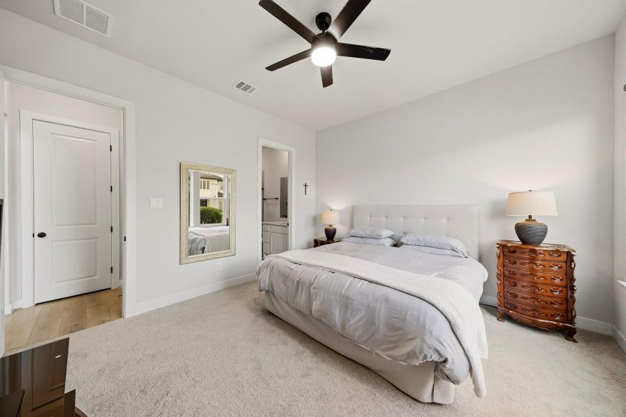 A private ensuite bath enhances this downstairs bedroom, creating a comfortable, self-contained retreat ideal for overnight guests or multi-generational living.