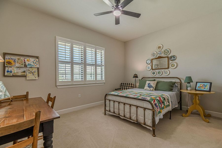 Carpeted bedroom with baseboards and ceiling fan