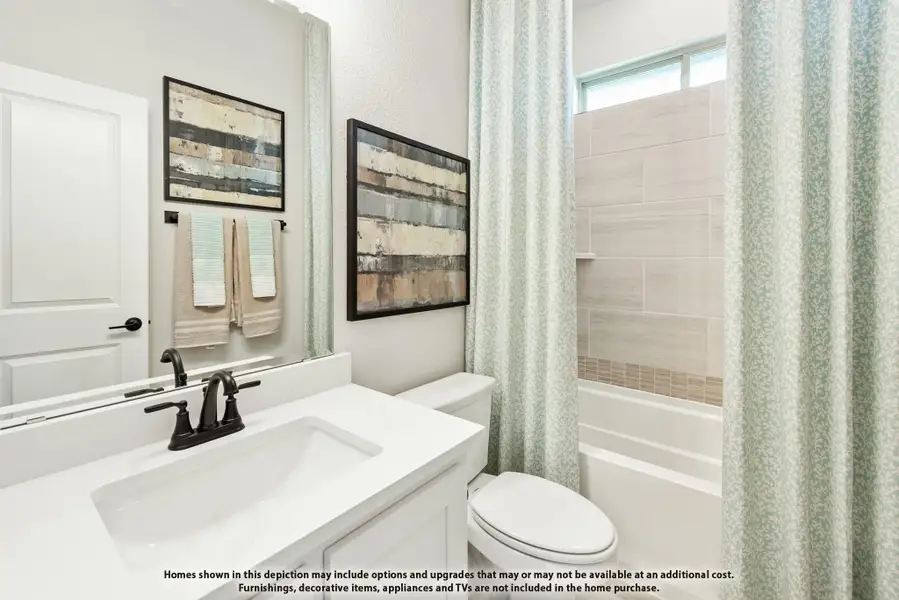 Full bathroom with white vanity, dark faucet, toilet, and tiled tub-shower combo with curtain Full bathroom with white vanity, dark faucet, toilet, and tiled tub-shower combo with curtain