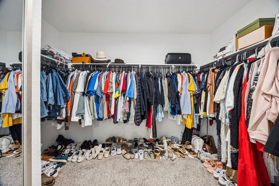 Expansive primary closet offering ample storage and organization for all your wardrobe essentials. Expansive primary closet offering ample storage and organization for all your wardrobe essentials.