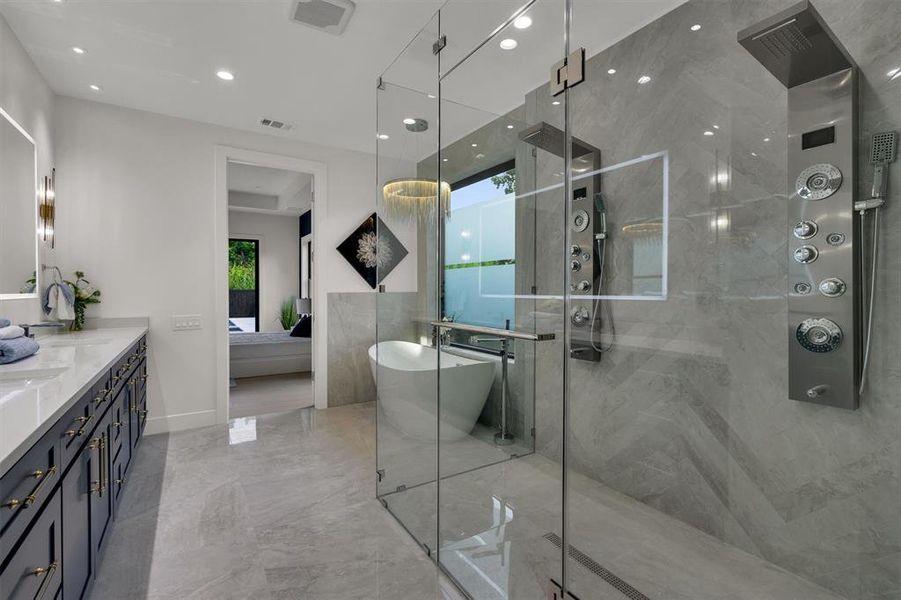 Bathroom featuring shower with separate bathtub, vanity, and a wealth of natural light