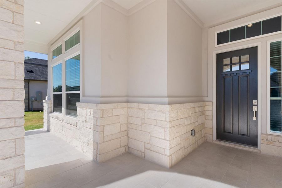 Doorway to property with stone siding