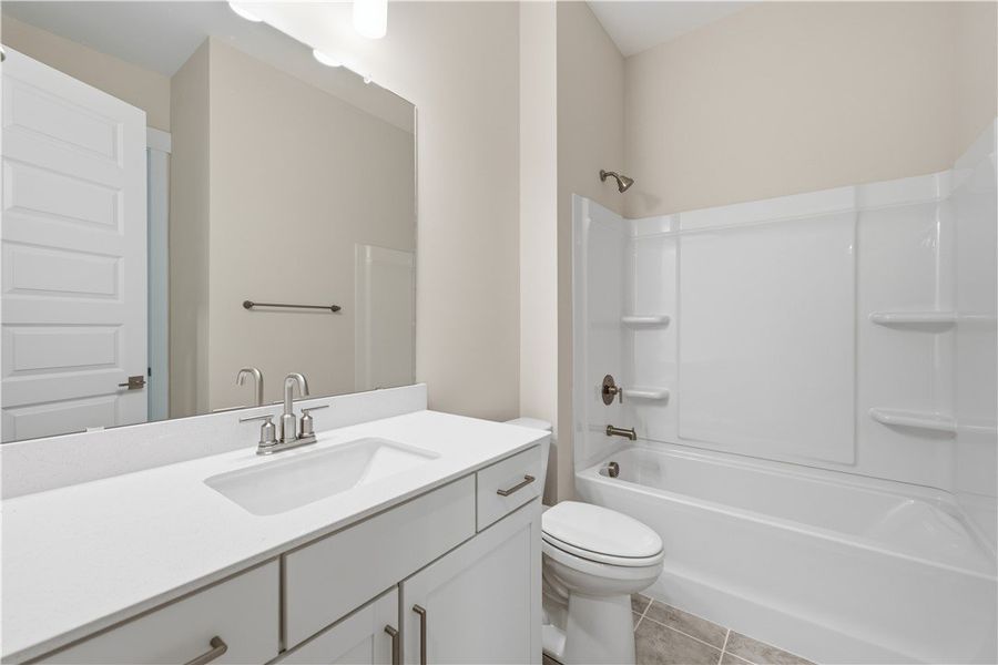 A modern bathroom features a clean white vanity pa