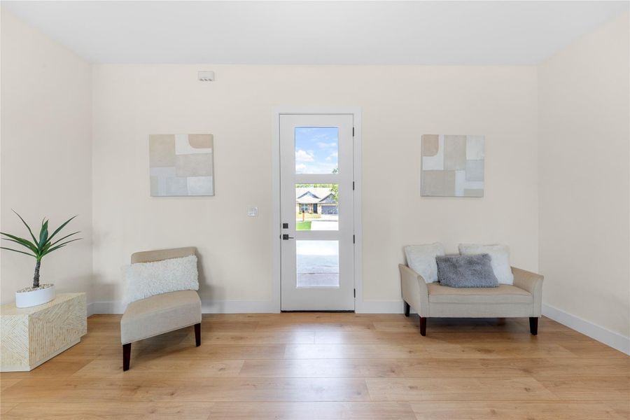 Living area featuring light wood-style flooring and baseboards Living area featuring light wood-style flooring and baseboards
