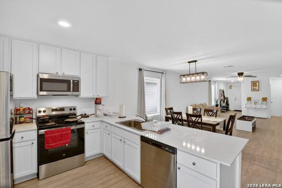 A well-appointed kitchen flows seamlessly into the dining area, creating an inviting open-concept living space. A well-appointed kitchen flows seamlessly into the dining area, creating an inviting open-concept living space.