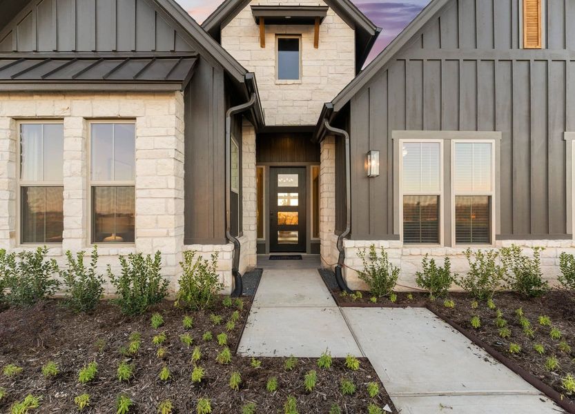Front exterior of a new home in Fulshear Lakes Gardens, Fulshear, TX, highlighting curb appeal (Image 18). Front exterior of a new home in Fulshear Lakes Gardens, Fulshear, TX, highlighting curb appeal (Image 18).