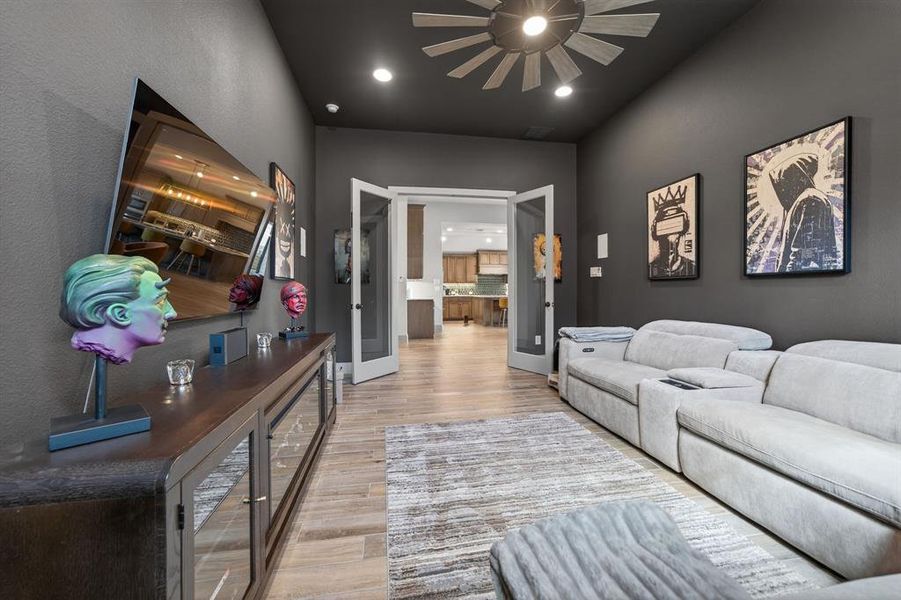 Living area with light wood-style flooring, recessed lighting, and ceiling fan Living area with light wood-style flooring, recessed lighting, and ceiling fan