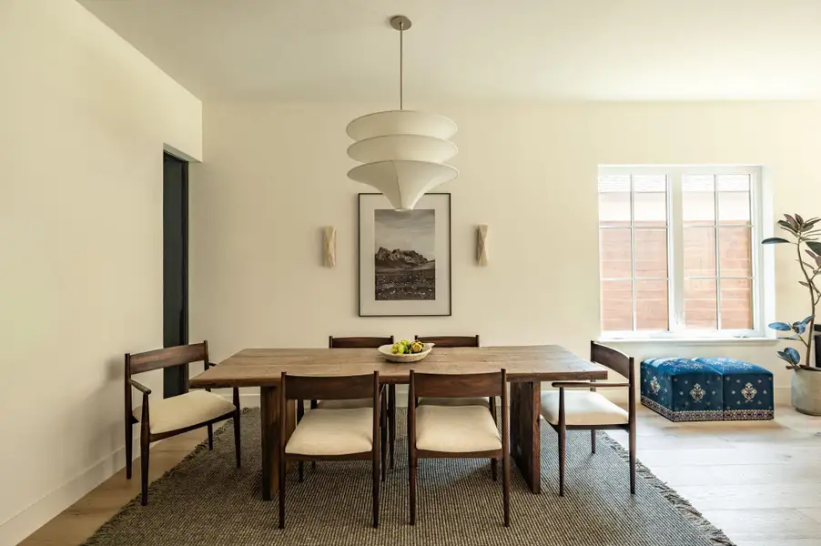 Fine wood flooring and a large multi-pane window elevate this formal dining space. Fine wood flooring and a large multi-pane window elevate this formal dining space.