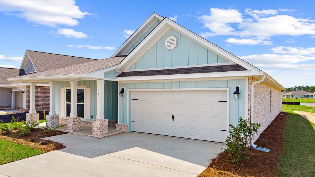 Front exterior of a new home in Owl's Head Farms, Freeport, FL, highlighting curb appeal (Image 17).