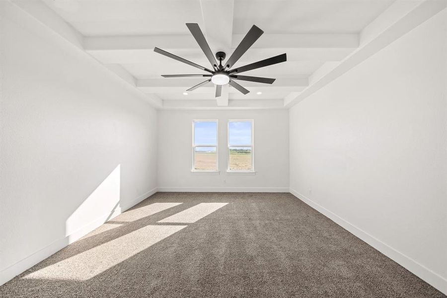 Carpeted empty room featuring beam ceiling and recessed lighting Carpeted empty room featuring beam ceiling and recessed lighting