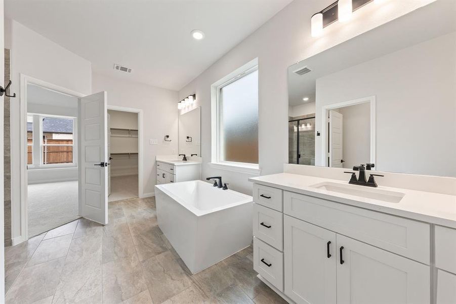 Featuring dual vanities, soaking tub, spacious walk in shower and his & her closets, you'll fend everything you have been searching for in this dream owner's bath! Featuring dual vanities, soaking tub, spacious walk in shower and his & her closets, you'll fend everything you have been searching for in this dream owner's bath!
