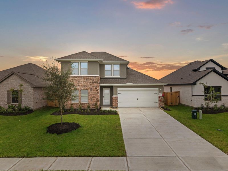 Front exterior of a new home in Windrose Green, Angleton, TX, highlighting curb appeal (Image 21). Front exterior of a new home in Windrose Green, Angleton, TX, highlighting curb appeal (Image 21).