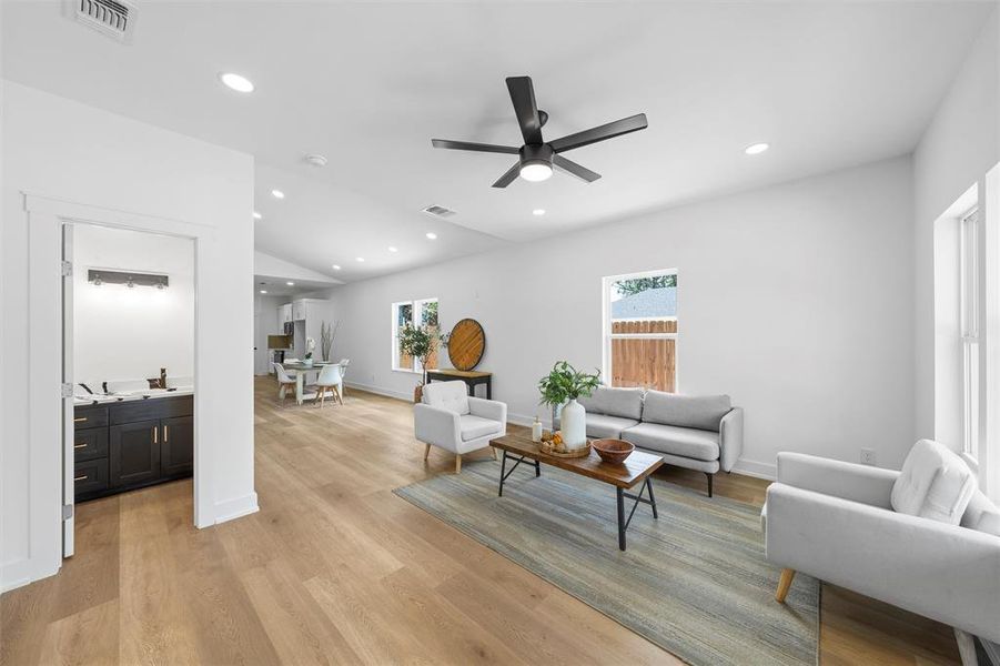 Living room with ceiling fan, recessed lighting, and light wood-style flooring Living room with ceiling fan, recessed lighting, and light wood-style flooring