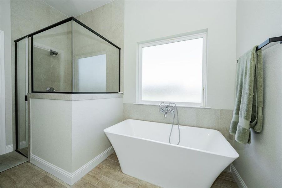 Bathroom with a stall shower and a freestanding bath Bathroom with a stall shower and a freestanding bath