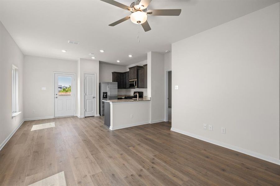 Unfurnished living room with recessed lighting, light wood finished floors, and a ceiling fan