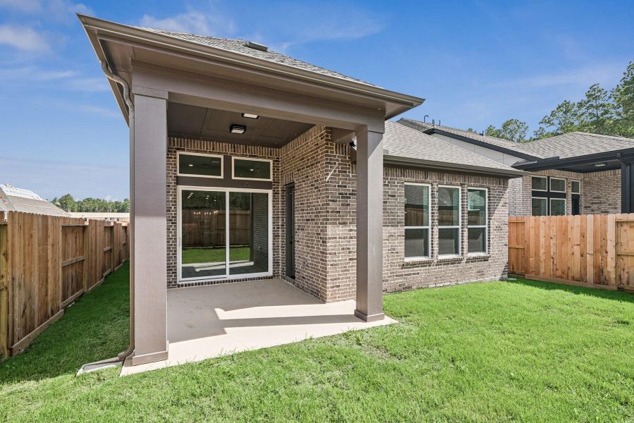 Front exterior of a new home in The Highlands 40', Porter, TX, highlighting curb appeal (Image 21). Front exterior of a new home in The Highlands 40', Porter, TX, highlighting curb appeal (Image 21).