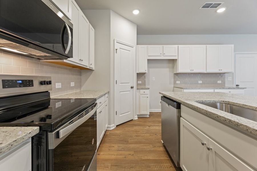A kitchen with white cabinets. A kitchen with white cabinets.