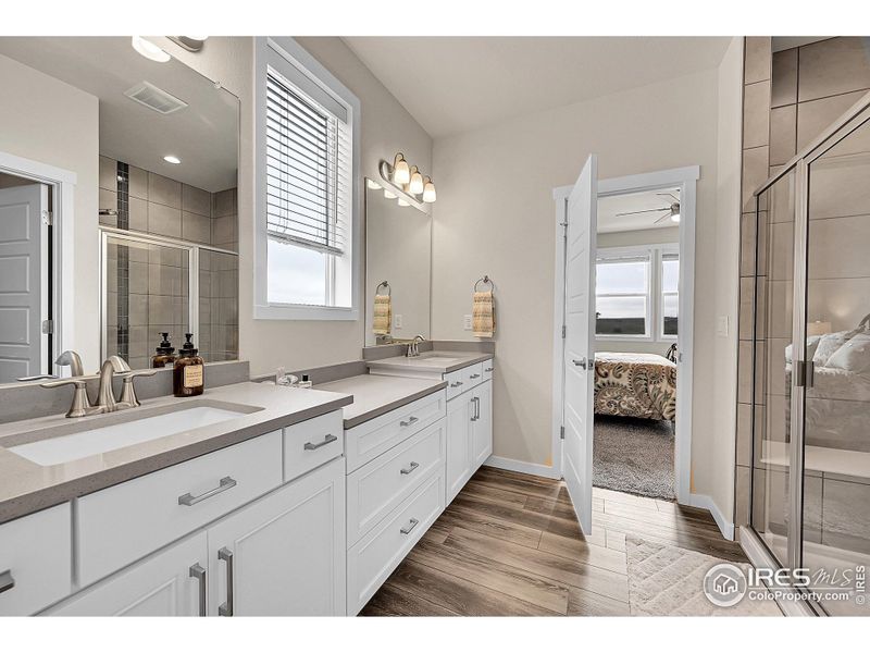 Primary Bathroom with upgraded cabinets and quartz counters