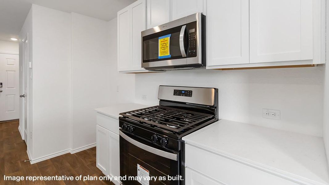 Kitchen featuring stainless steel appliances, white cabinetry, dark wood finished floors, recessed lighting, and light stone counters