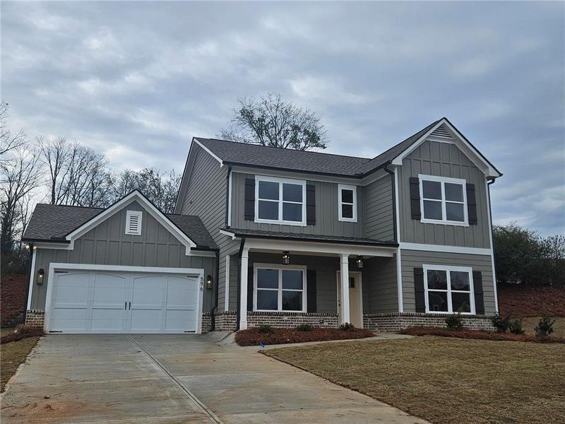Front exterior of a new home in Calgary Downs, Winder, GA, highlighting curb appeal (Image 5). Front exterior of a new home in Calgary Downs, Winder, GA, highlighting curb appeal (Image 5).