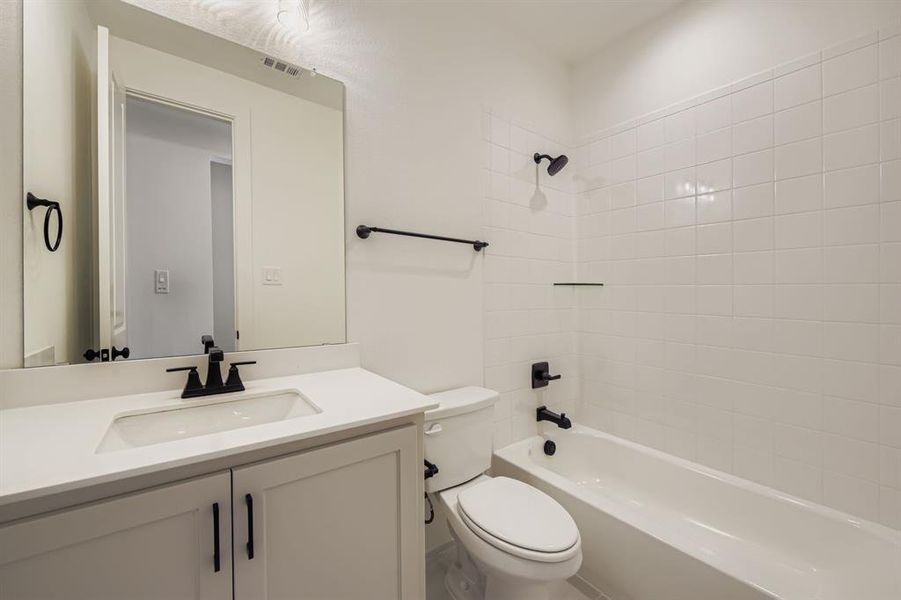 Full bathroom featuring vanity and washtub / shower combination