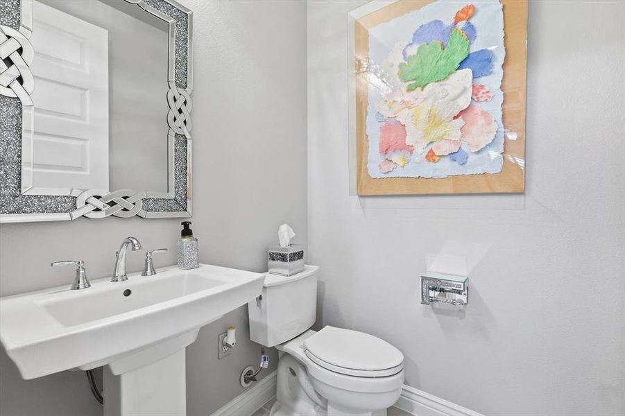 White pedestal sink with chrome faucet hardware