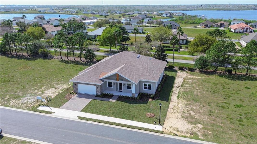 Front exterior of a new home in , Lake Alfred, FL, highlighting curb appeal (Image 27).