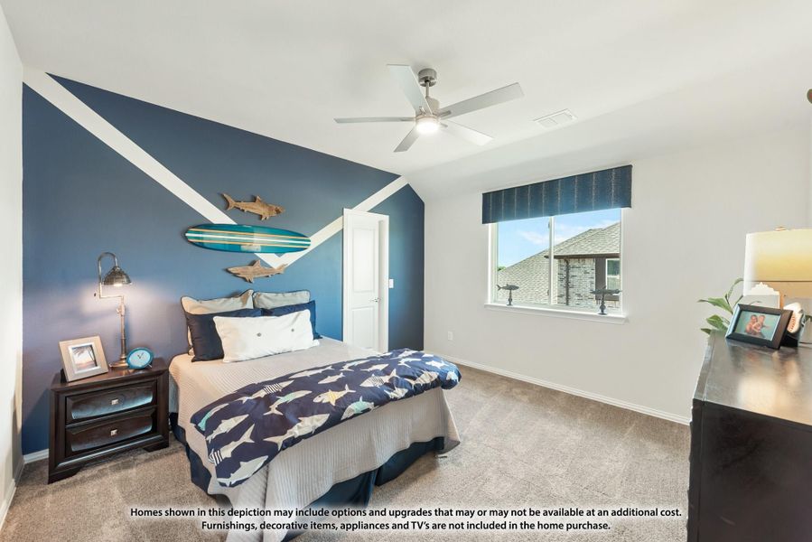 Bedroom with blue accent wall, ceiling fan, carpet flooring, and nautical-themed decor including a surfboard wall display