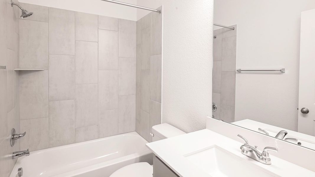 Full bathroom with bathing tub / shower combination and vanity Full bathroom with bathing tub / shower combination and vanity